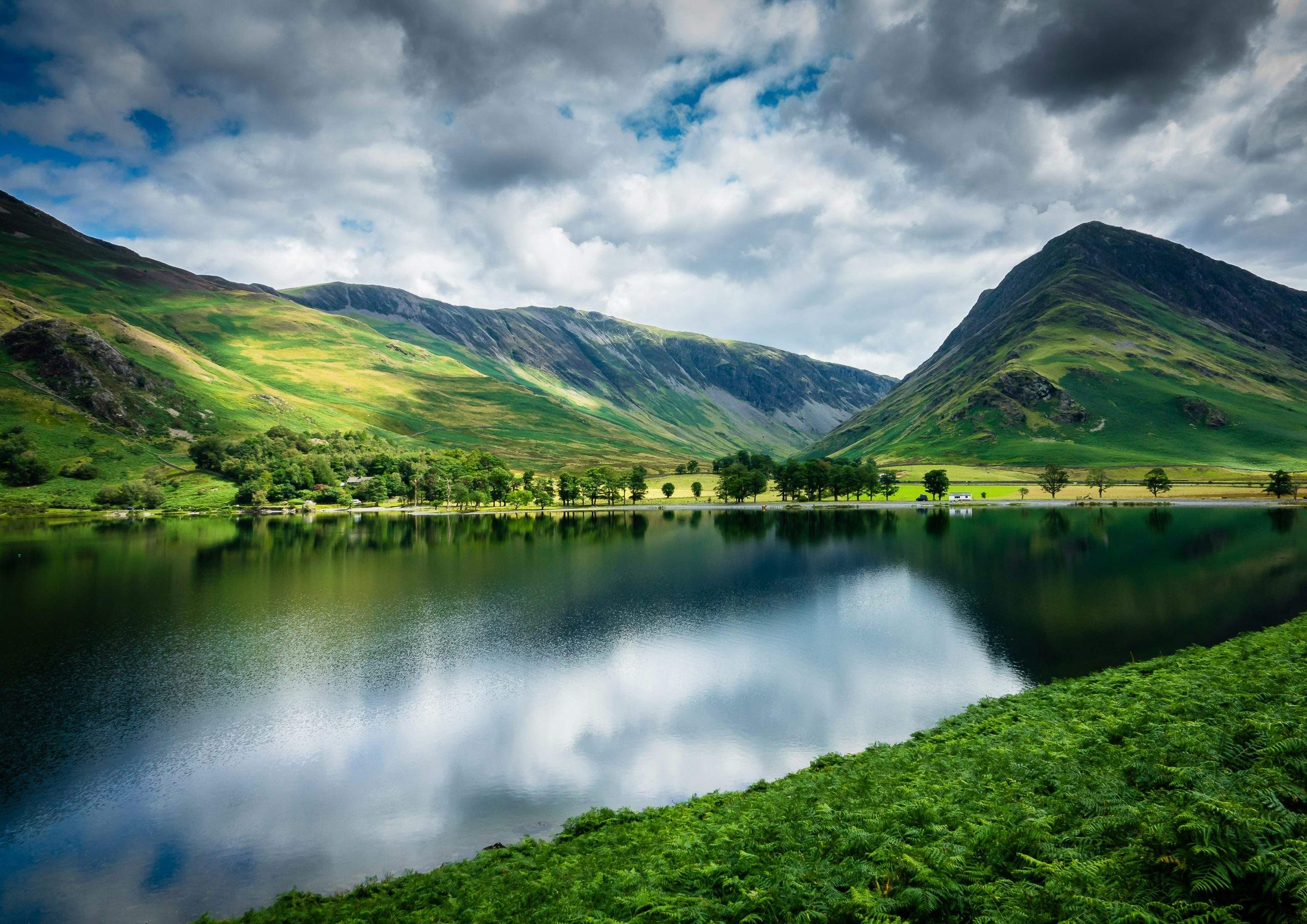 Green fells beside a lake in the Lake District, Cumbria
